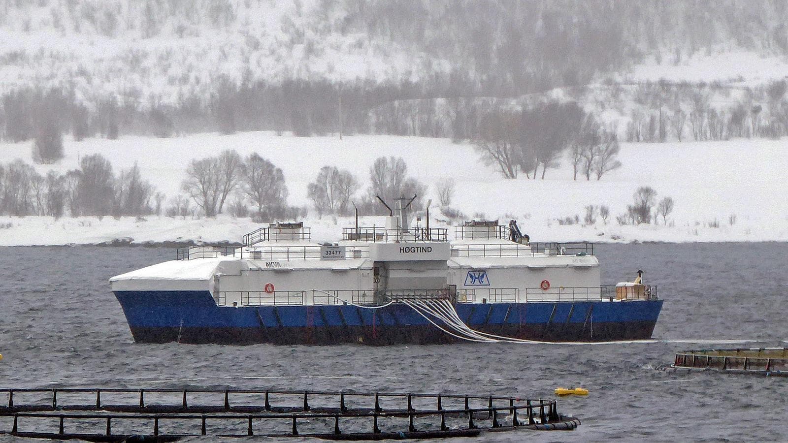 A Norwegian fish farm and service vessel near Harstad in winter conditions.